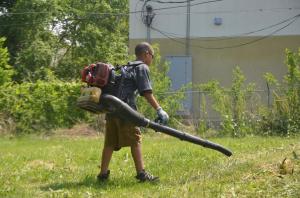 boy using blower on yard